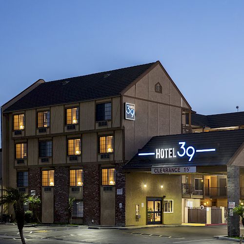 The image shows a three-story hotel building with the name 